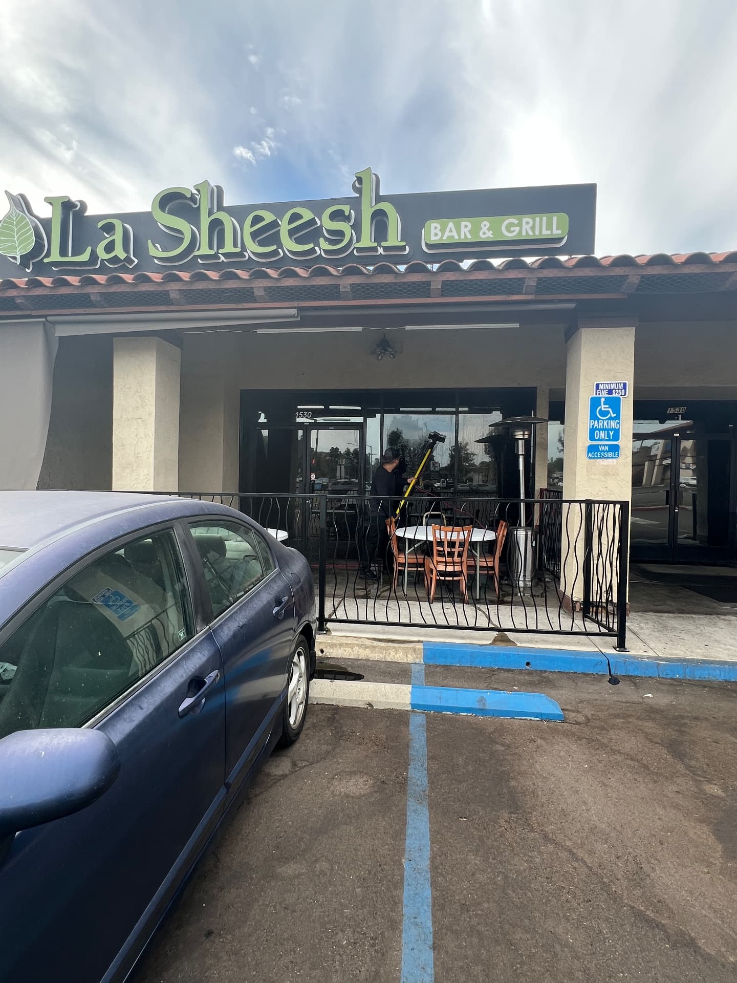 Technician cleaning a restaurant storefront window